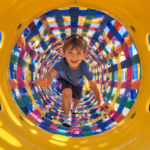 Kid in the woven rope tunnel